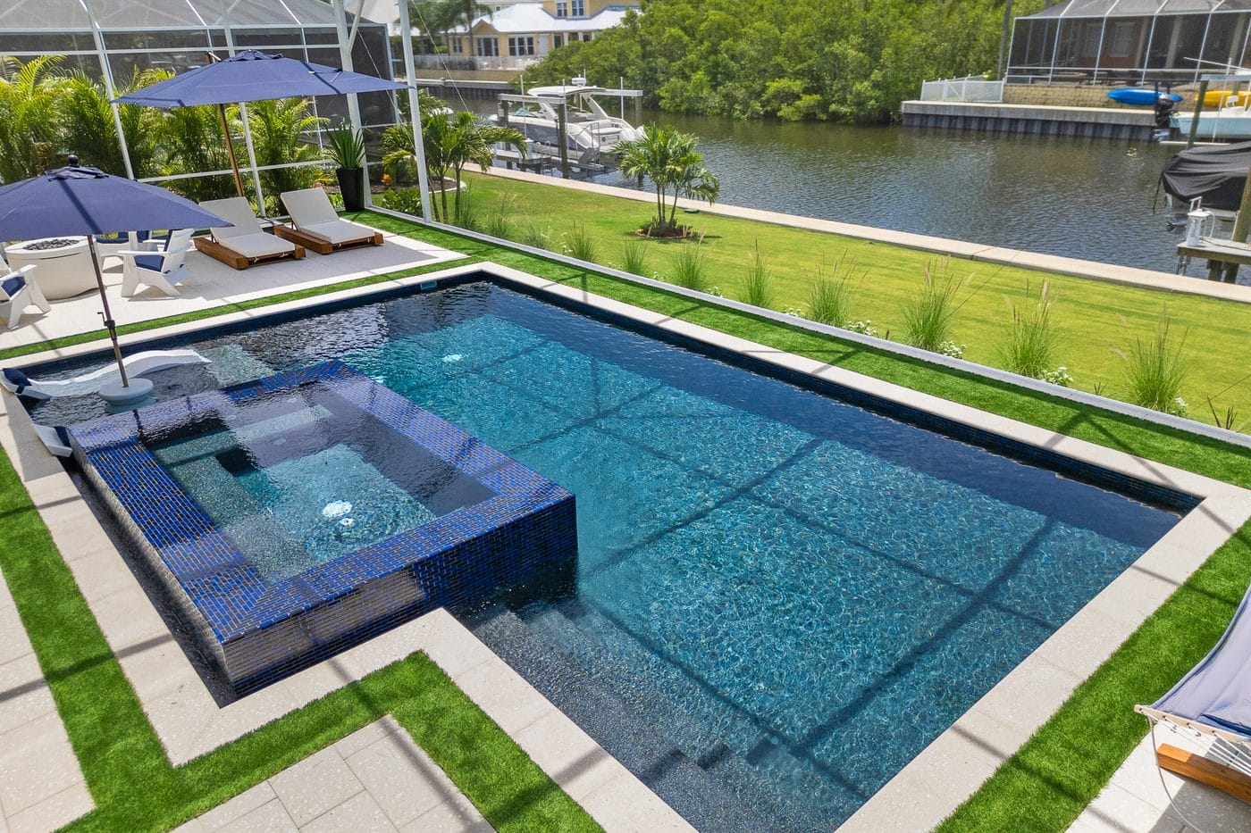 Aerial view of a flagship Pool Perfection freeform custom concrete pool and spa at a waterfront Tampa Bay estate
