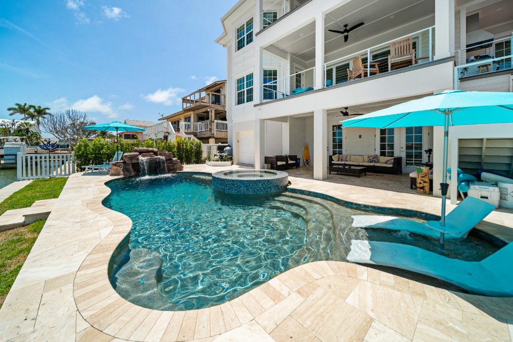 Water-level close-up of custom hand-set glass tile on a Pool Perfection pool